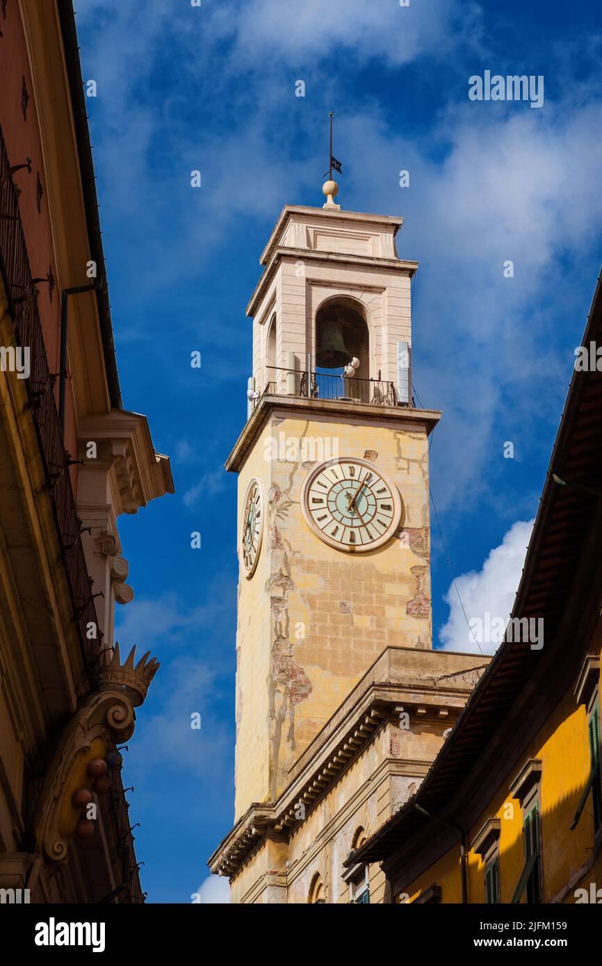 View of Pisa historical center with old clock tower and clouds Stock Photo