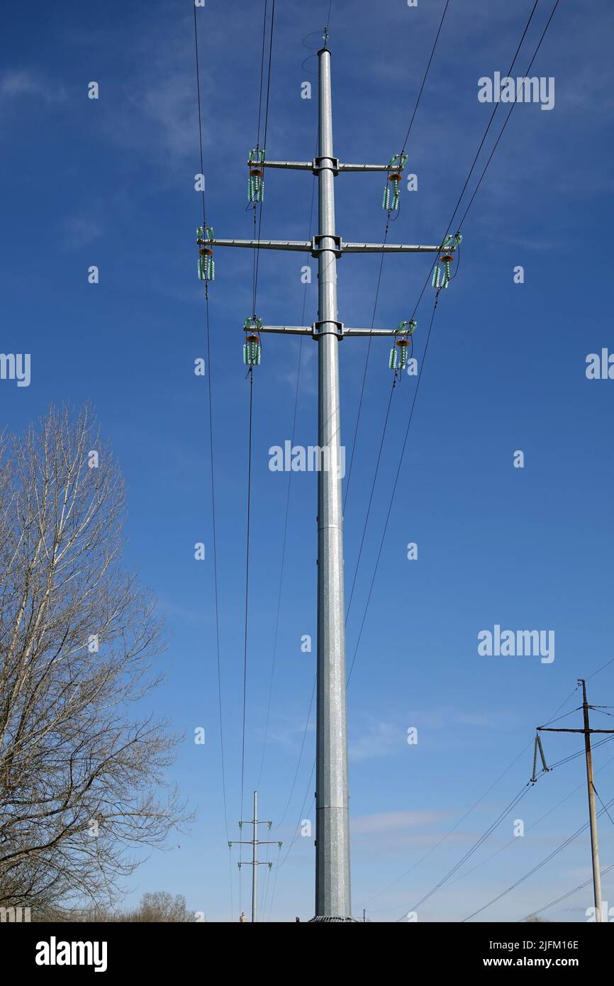 Poles with high-voltage wires against the sky Stock Photo - Alamy