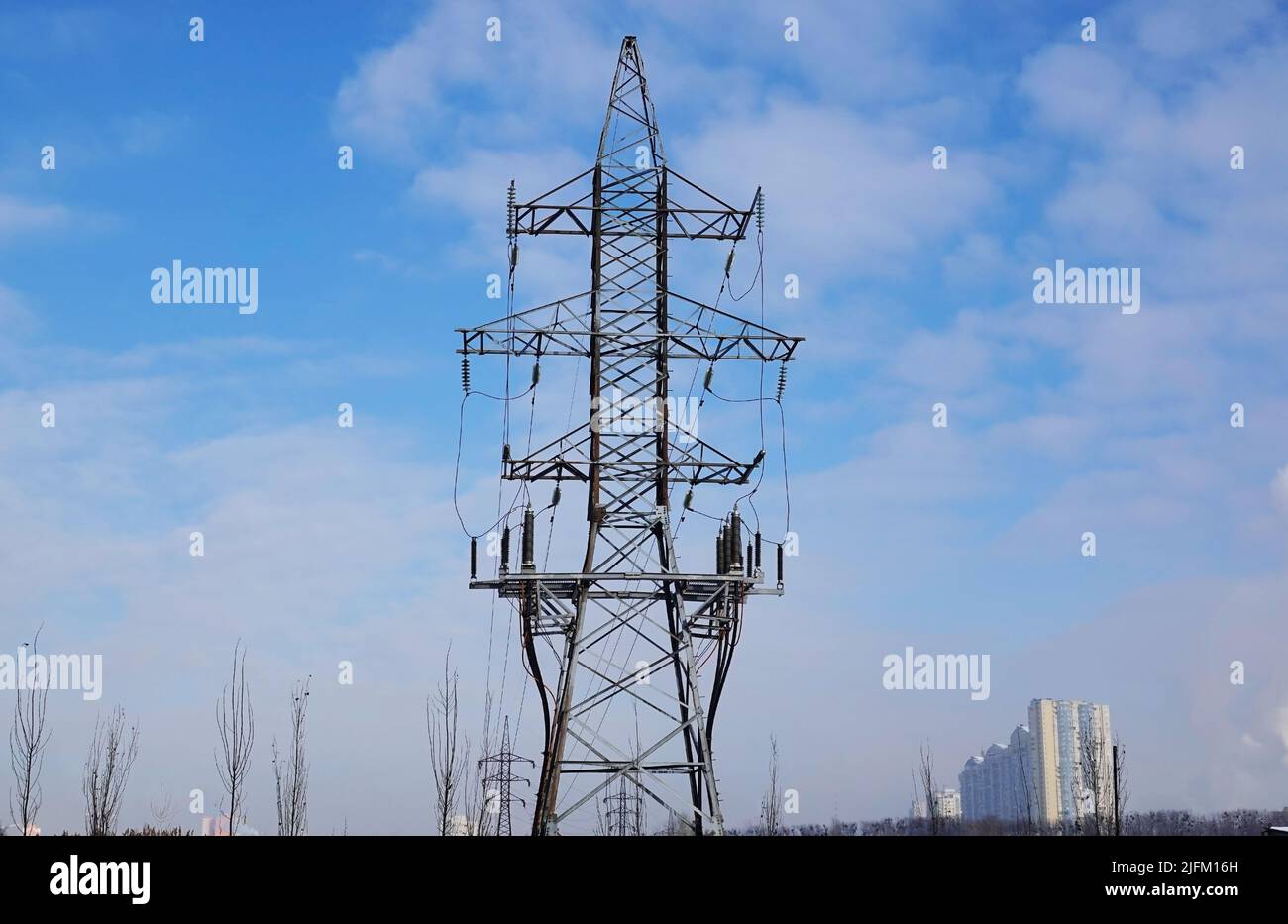 Poles with high-voltage wires against the sky Stock Photo - Alamy