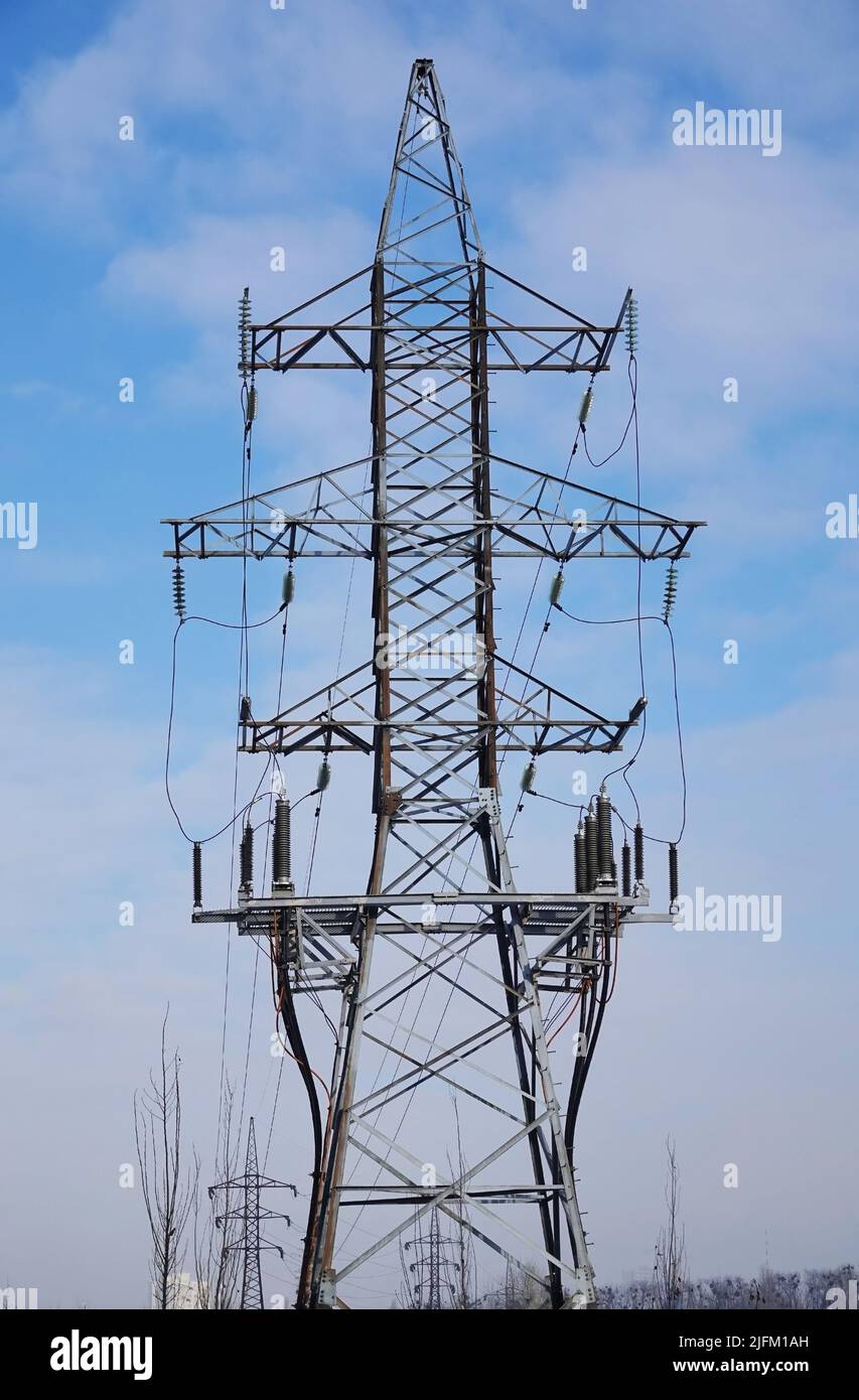 Poles with high-voltage wires against the sky Stock Photo - Alamy