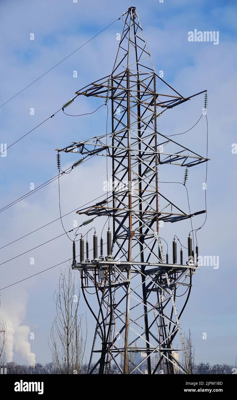 Poles with high-voltage wires against the sky Stock Photo - Alamy