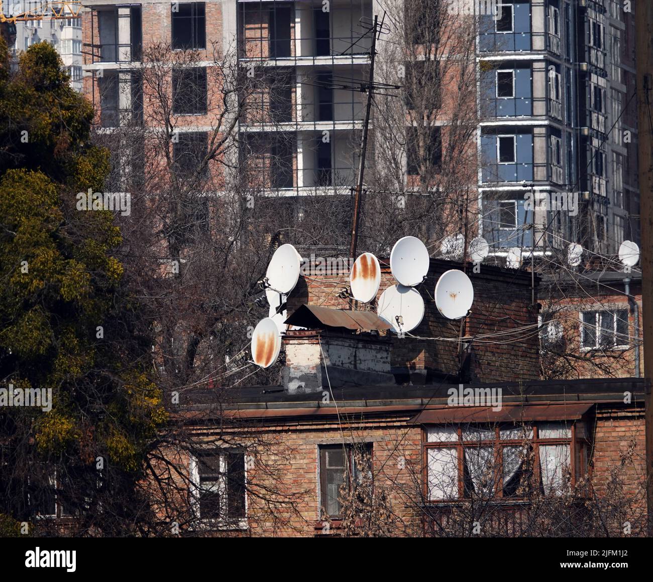 Plates for receiving TV channels on the roofs of houses Stock Photo