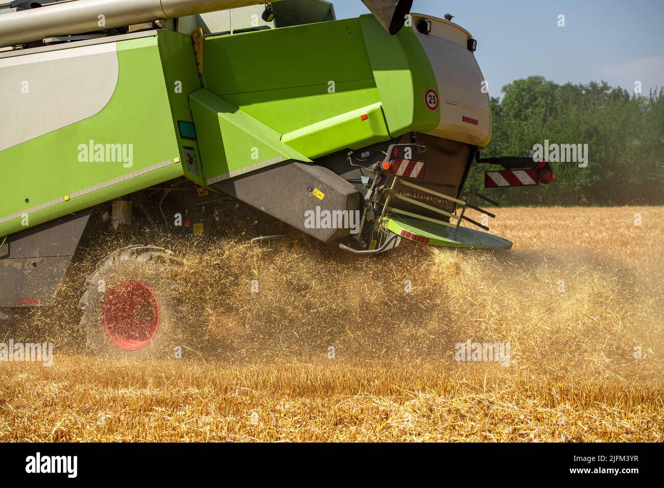 Combine harvester at work during wheat harvest. Wheat supply shortage, global food crisis, stockpiling. Stock Photo
