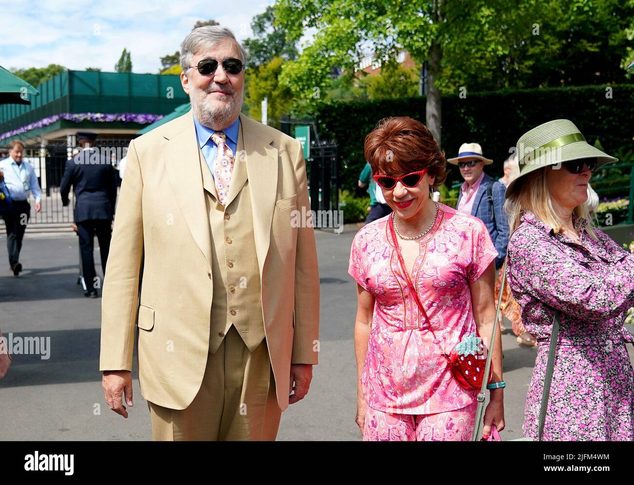 Stephen Fry and Kathy Lette arrive on day eight of the 2022 Wimbledon Championships at the All England Lawn Tennis and Croquet Club, Wimbledon. Picture date: Monday July 4, 2022. Stock Photo