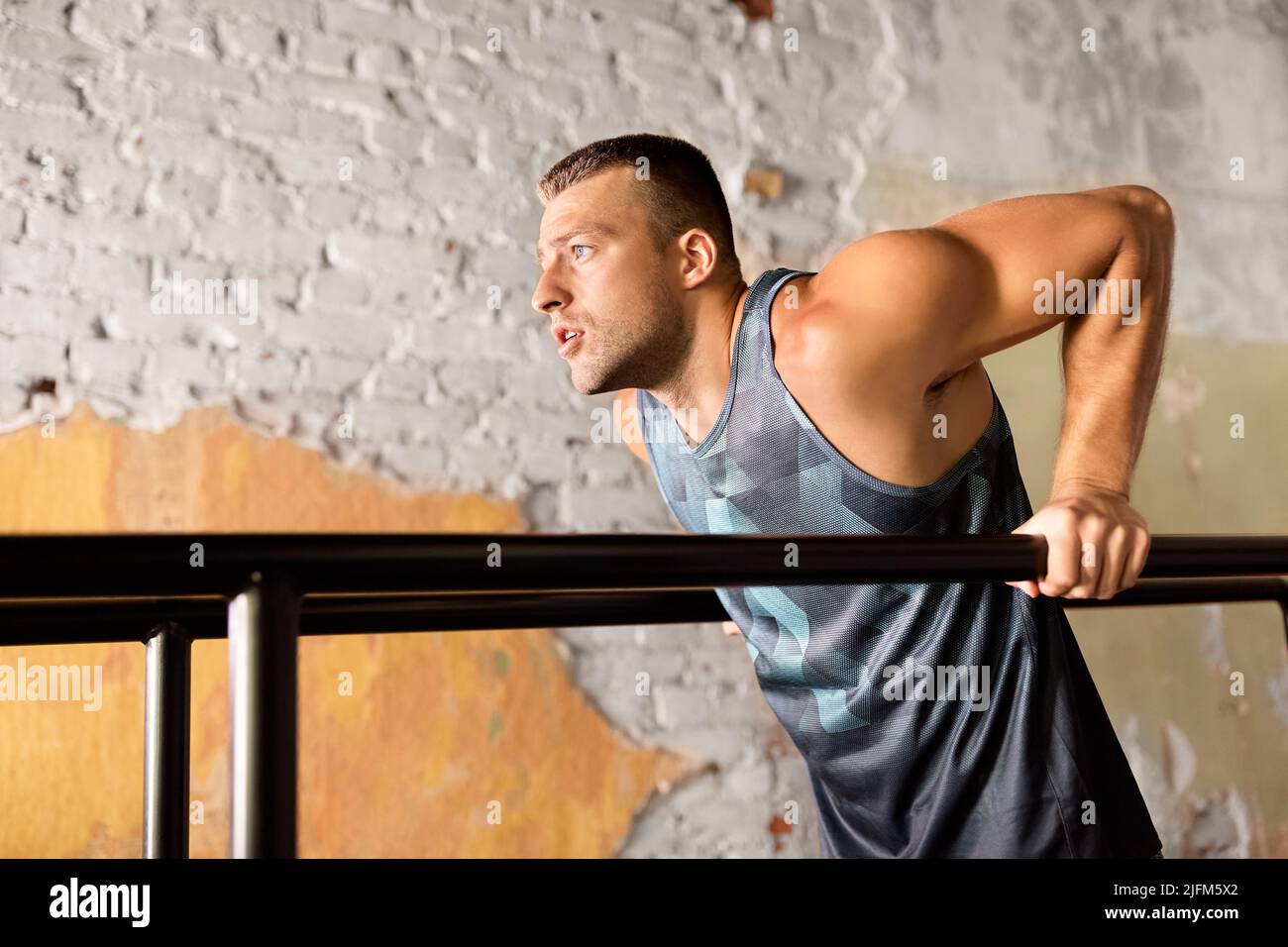 man doing triceps dip on parallel bars in gym Stock Photo Alamy