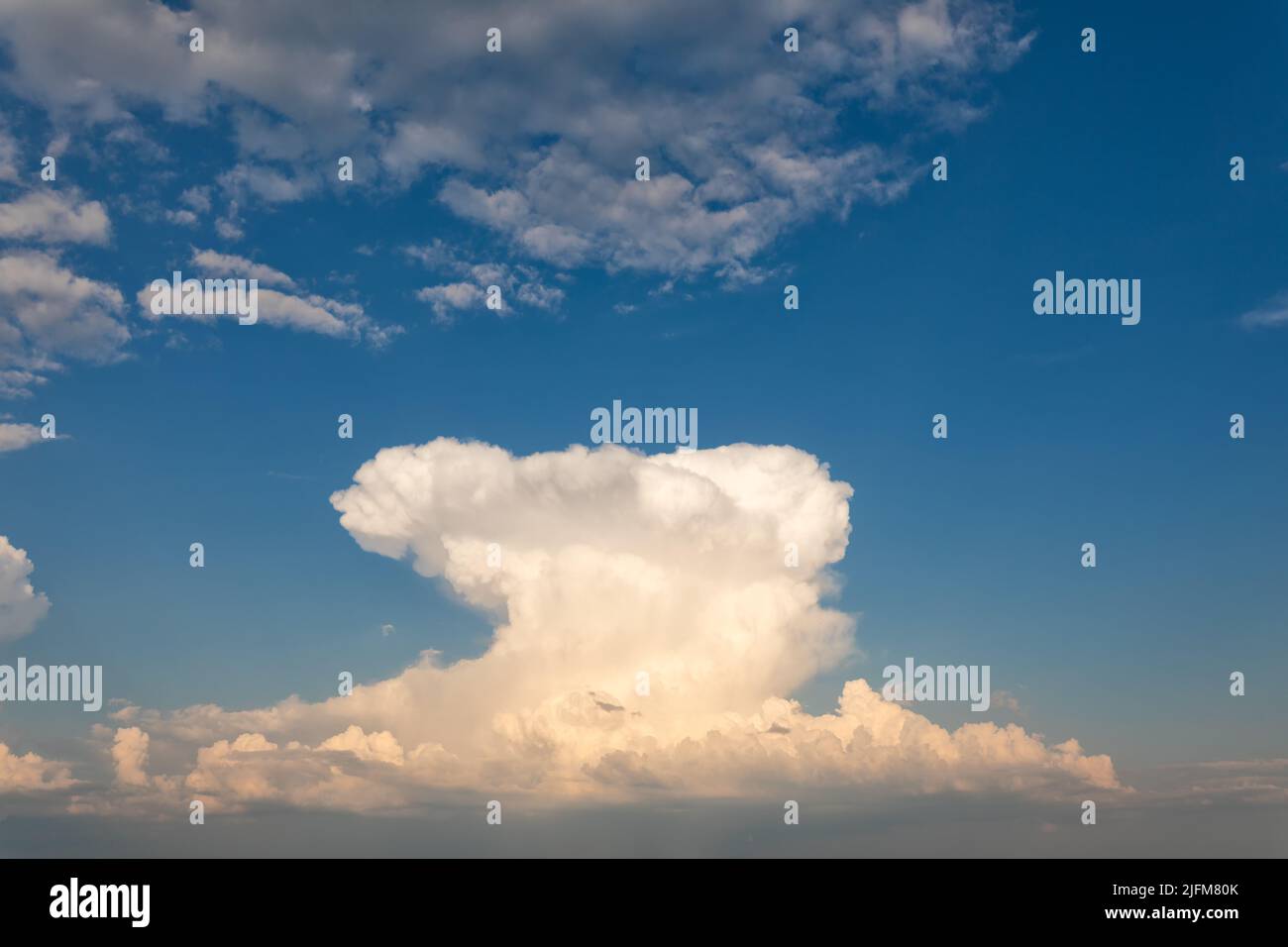 A big white cloud in a bright blue sky Stock Photo - Alamy