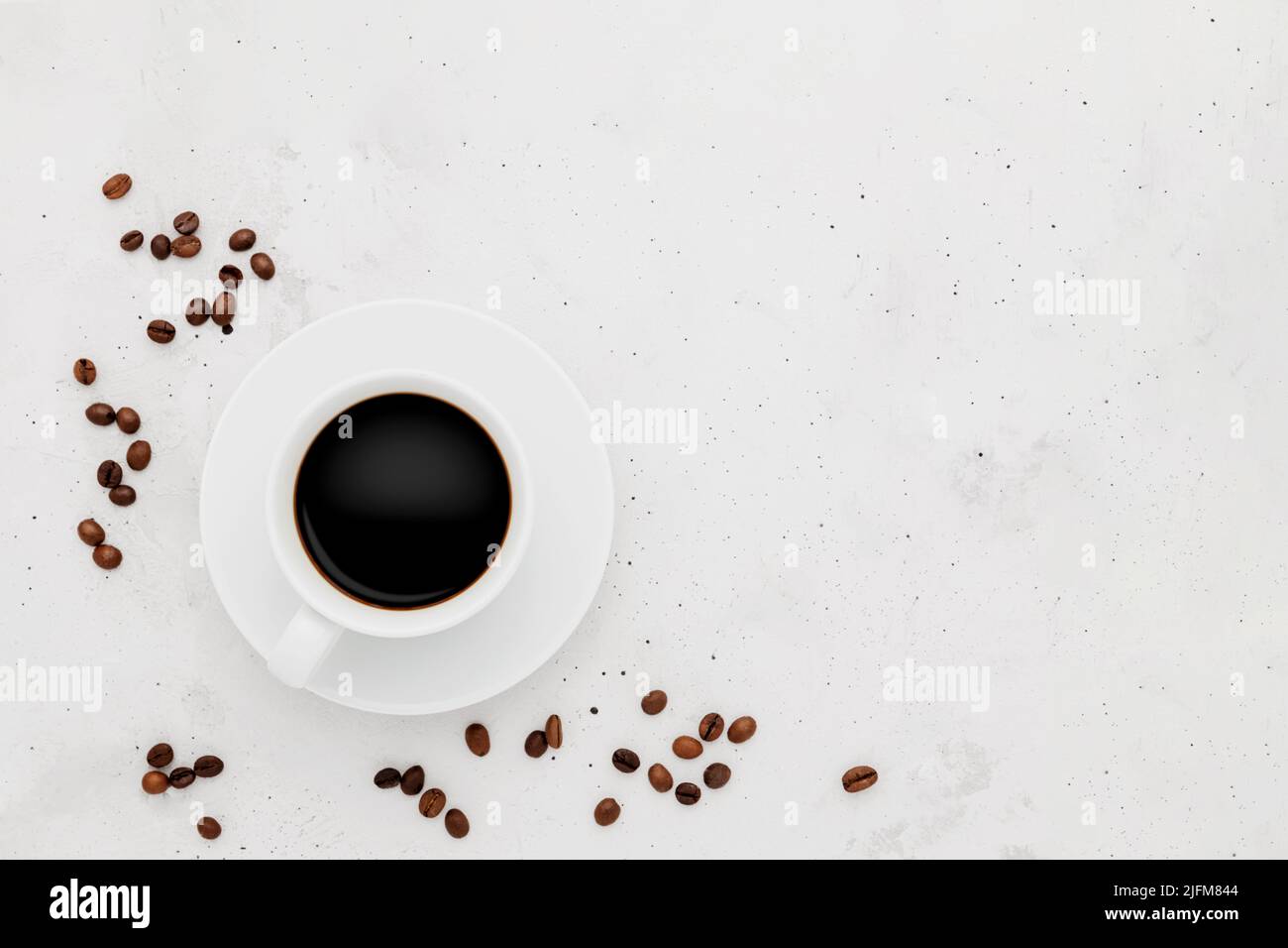 Top view on flat lay with single one full coffee cup composition on gray white concrete background. Tea mug collection layout. Dried coffee beans around. Black espresso or americano. Copy space area Stock Photo