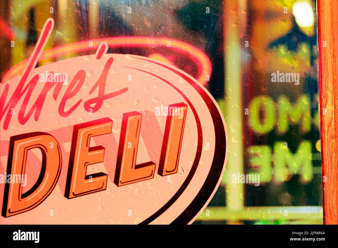 Raindrops on a  deli or diner window for a retro styled 1950s eatery Stock Photo