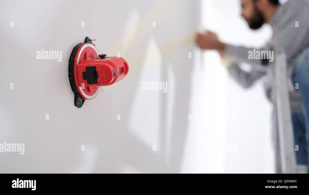 Builder using professional measuring device for marks Stock Photo