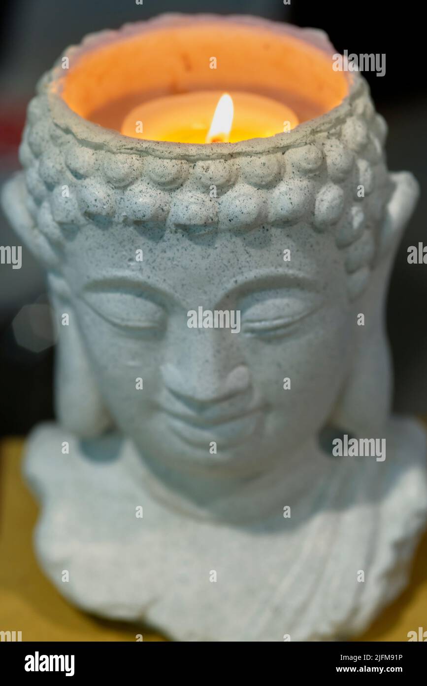 Buddha Head with Candle Stock Photo