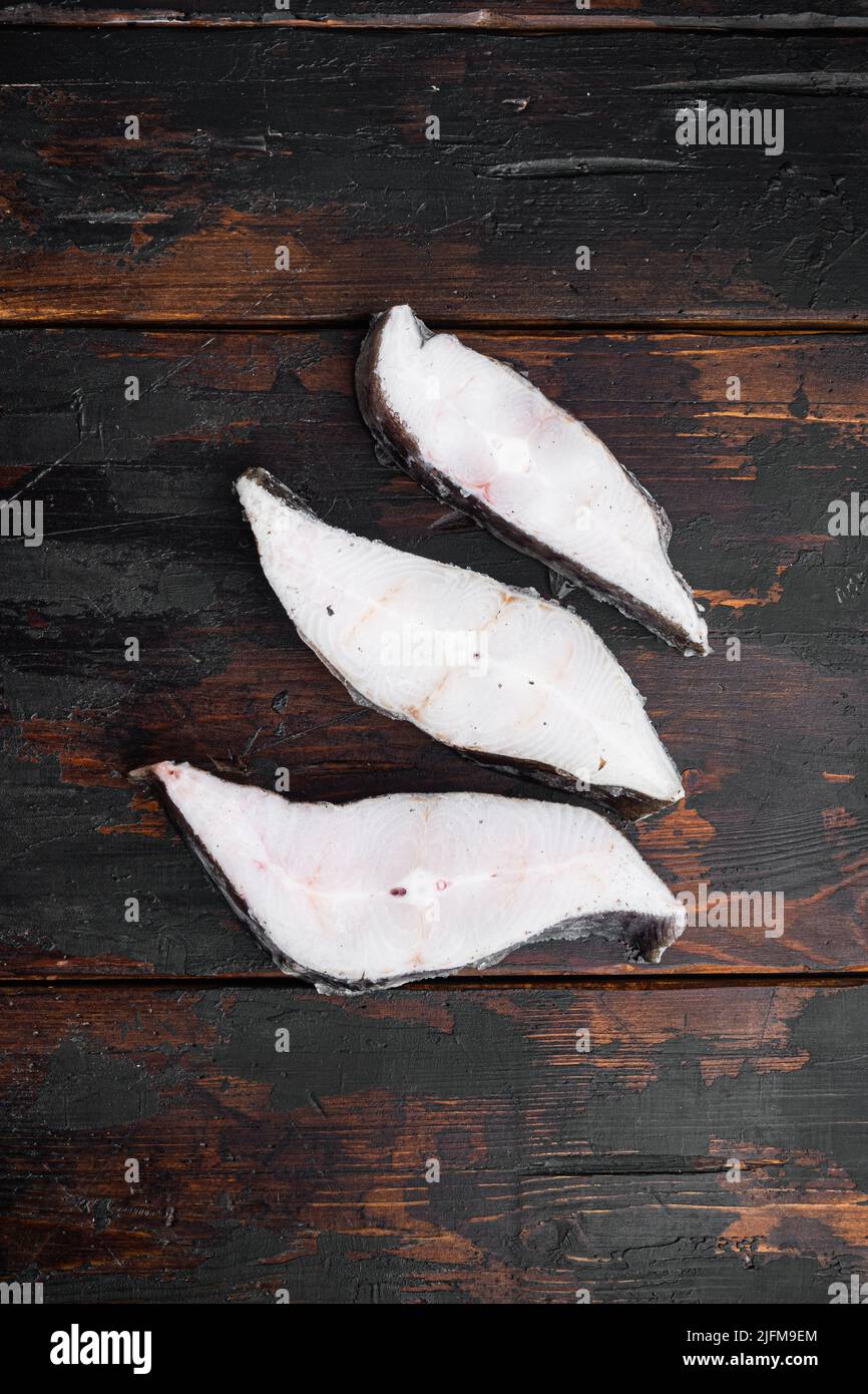 Frozen fish cut, on old dark wooden table background, top view flat lay ...