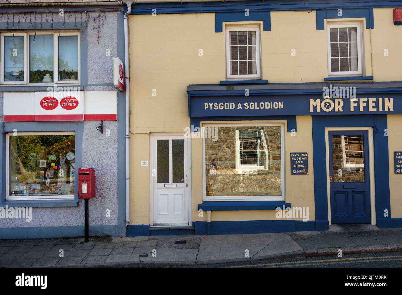 The post box and Post Office next to the fish and chip shop in St Dogmaels, Pembrokeshire, Wales Stock Photo