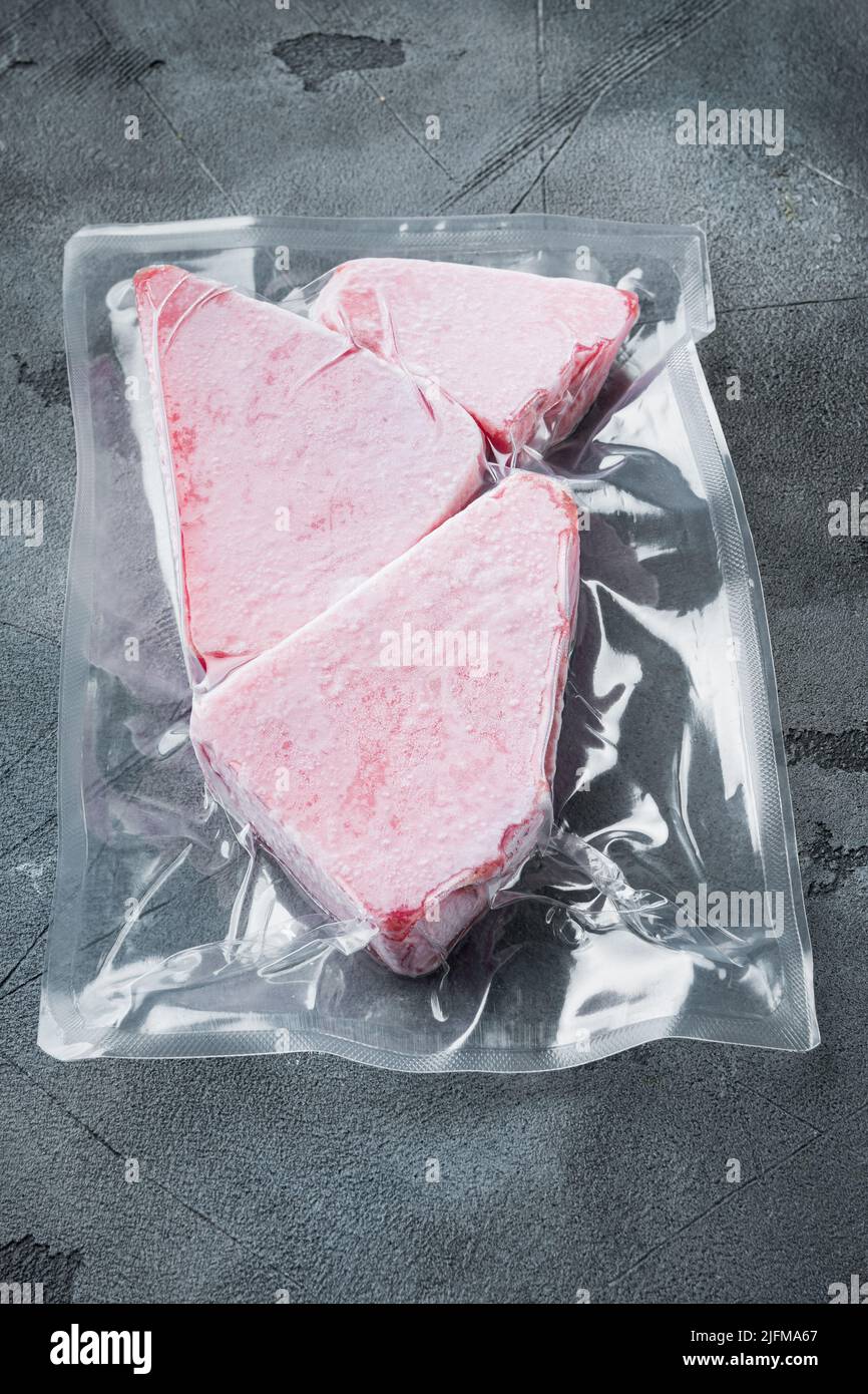 Frozen Tuna fish steak in a vacuum plastic package, on gray stone background Stock Photo Alamy