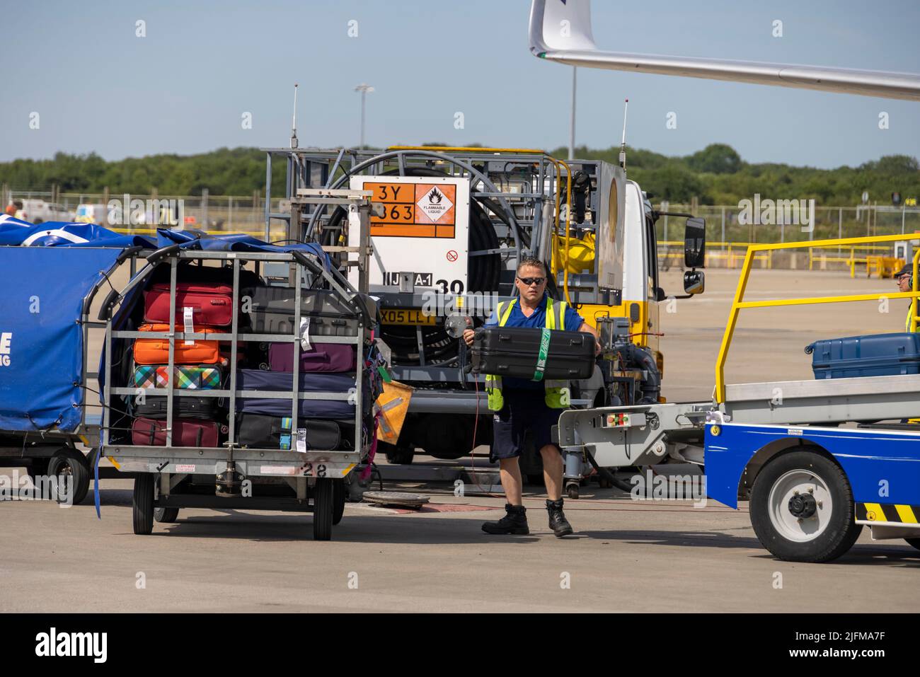 pic shows:  Baggage handlers loading luggage onto a Ryanair flight at London Stansted      Picture by Gavin Rodgers/ Pixel8000  June 2022 Stock Photo