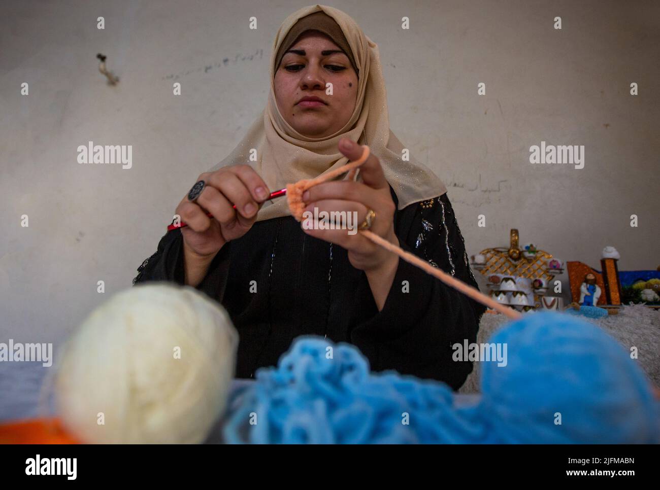 Gaza, Palestine. 2nd July, 2022. Gaza, Palestine. 2 July 2022. Reham Sherab creates wool sheep in the southern Gaza Strip ahead of the Muslim Eid of Al-Adha. Eid-Adha or ''Day of Sacrifice'' occurs at the end of the Hajj or Pilgrimage and honours prophet Ibrahim's readiness to sacrifice his son in obedience to God, before being stopped by God himself and sacrificing a lamb instead (Credit Image: © Yousef Mohammed/IMAGESLIVE via ZUMA Press Wire) Stock Photo
