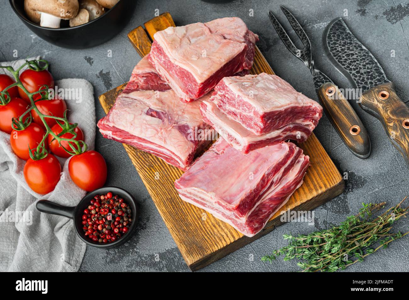 Raw Black Angus Marbled Beef Ribs, with ingredients , on gray stone ...