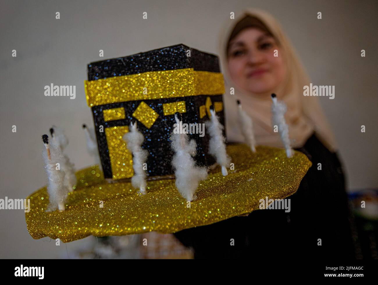 July 2, 2022, Gaza, Palestine: Gaza, Palestine. 2 July 2022.  Palestinian Reham Sherab creates a small Kaba at her home in the southern Gaza Strip ahead of the Muslim Eid of Al-Adha. Eid-Adha or ''Day of Sacrifice''  occurs at the end of the Hajj or Pilgrimage and honours prophet Ibrahim's readiness to sacrifice his son in obedience to God, before being stopped by God himself and sacrificing a lamb instead (Credit Image: © Yousef Mohammed/IMAGESLIVE via ZUMA Press Wire) Stock Photo