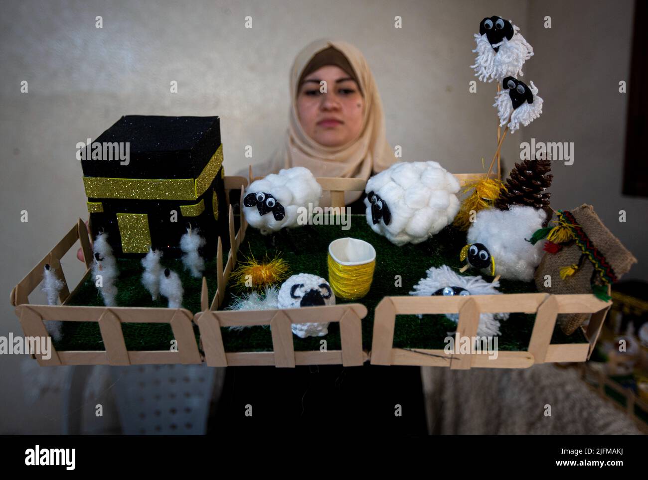 Gaza, Palestine. 2nd July, 2022. Gaza, Palestine. 2 July 2022. Palestinian Reham Sherab creates a small Kaba at her home in the southern Gaza Strip ahead of the Muslim Eid of Al-Adha. Eid-Adha or ''Day of Sacrifice'' occurs at the end of the Hajj or Pilgrimage and honours prophet Ibrahim's readiness to sacrifice his son in obedience to God, before being stopped by God himself and sacrificing a lamb instead (Credit Image: © Yousef Mohammed/IMAGESLIVE via ZUMA Press Wire) Stock Photo
