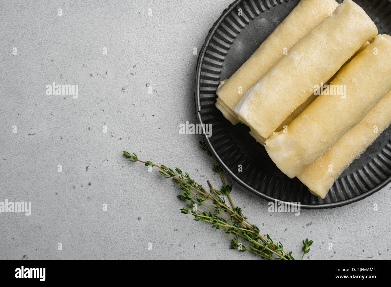 Frozen pancakes with meat on gray stone table background, top view flat ...