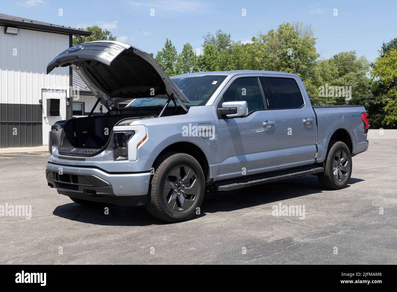 Tipton - Circa July 2022: Ford F-150 Lightning Frunk display. Ford offers the F150 Lightning all-electric truck in Pro, XLT, Lariat, and Platinum mode Stock Photo