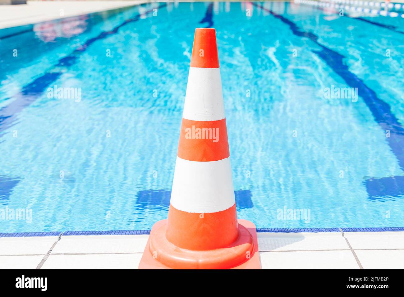 swimming pool repair safety cone on edge Stock Photo Alamy