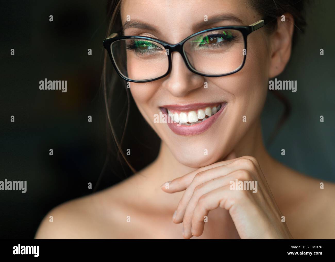 Close up photo of a happy smiling woman in eyeglasses. Eyesight health concept. Stock Photo