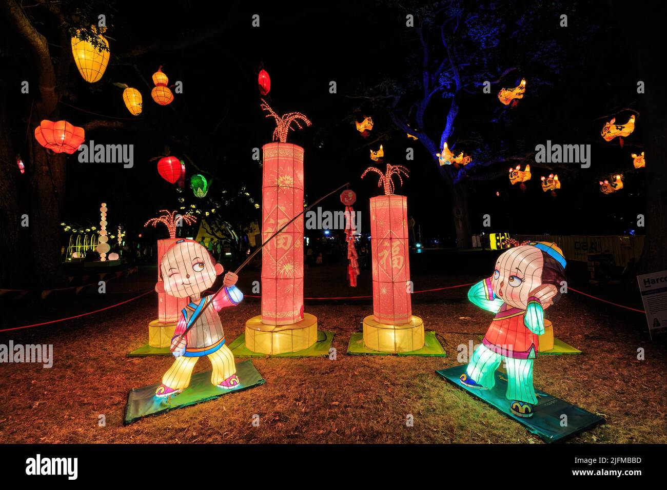Chinese New Year lanterns depicting children letting off fireworks in the Auckland Domain, Auckland, New Zealand Stock Photo
