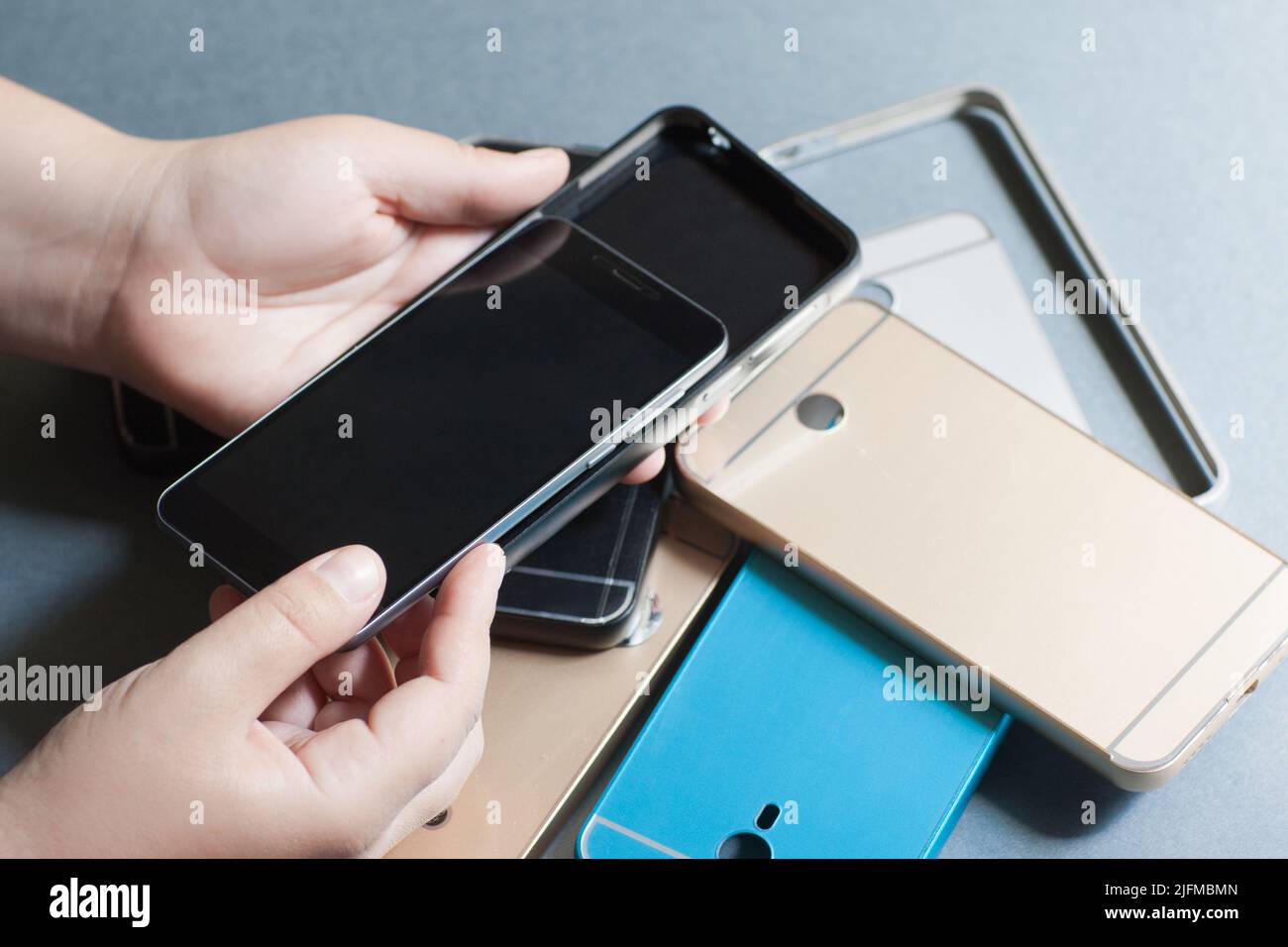 Plastic mobile phone cases variety on gray Stock Photo