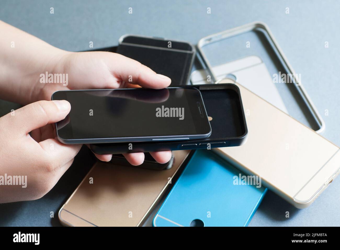 Plastic mobile phone cases variety on gray Stock Photo