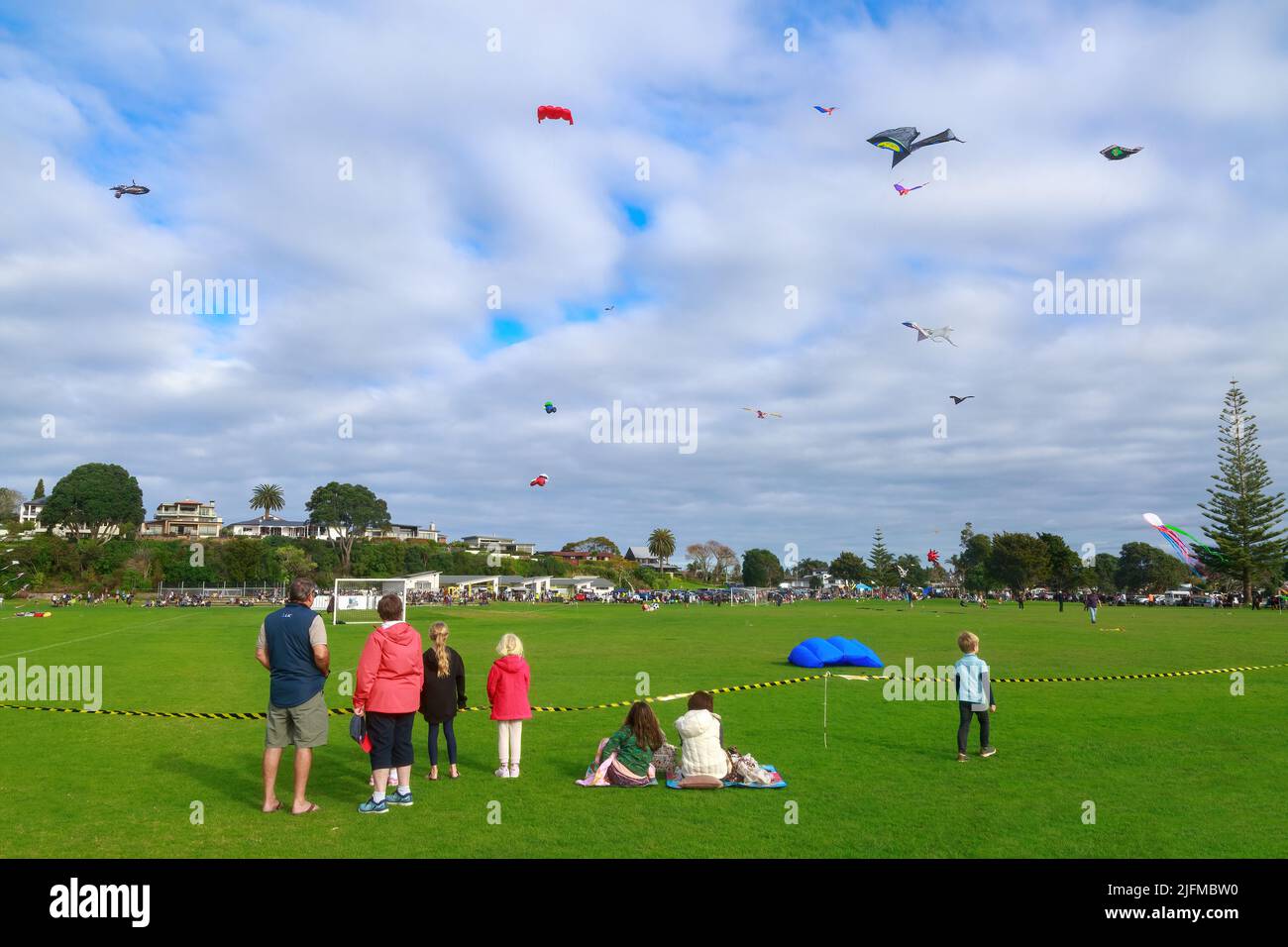 People look at a sky full of kites during celebrations of Matariki, the Maori new year, in Fergusson Park, Tauranga, New Zealand Stock Photo