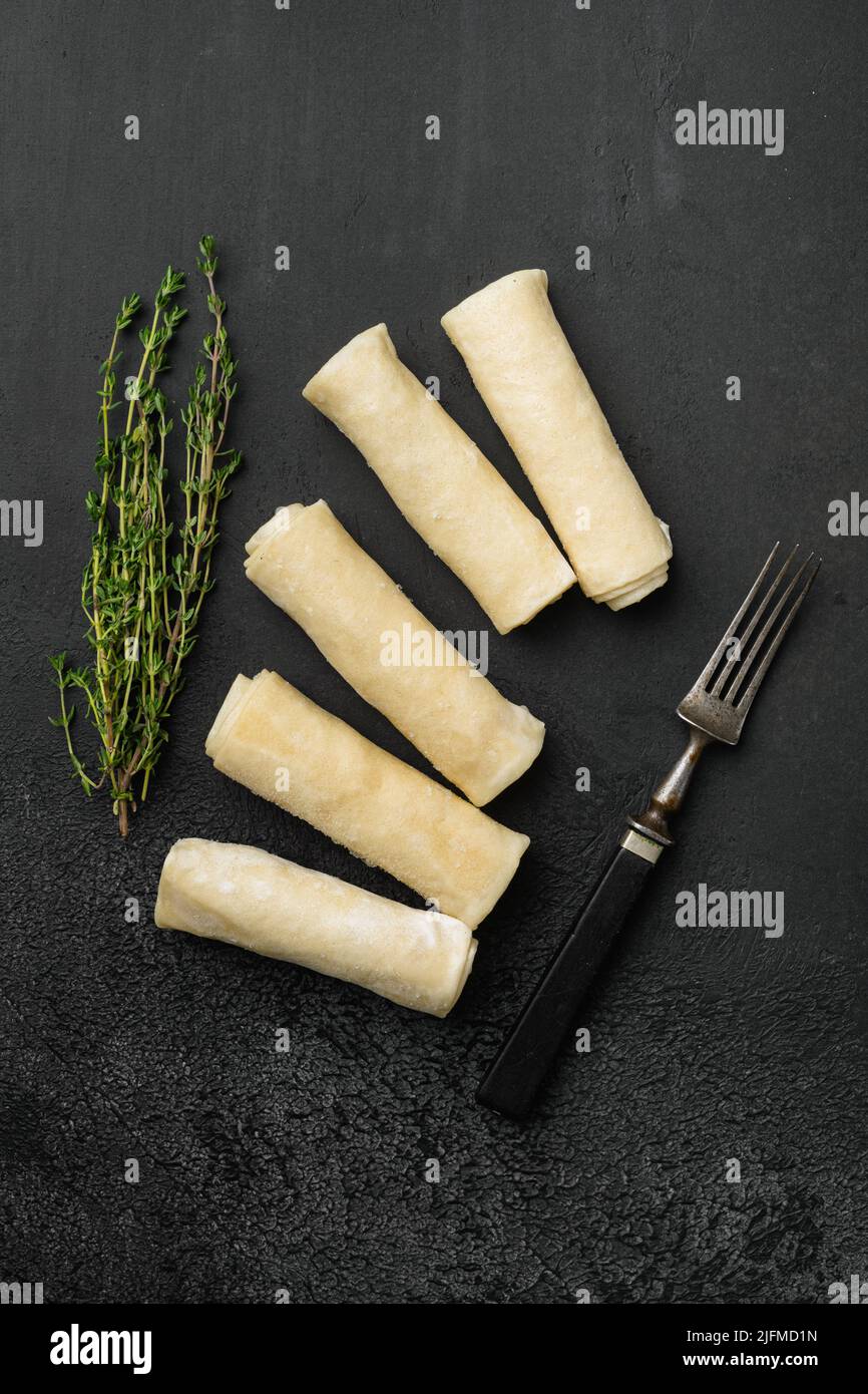 Frozen pancake on black dark stone table background, top view flat lay ...
