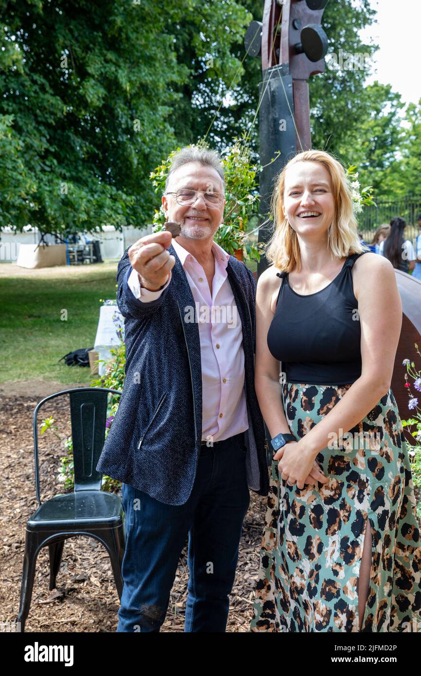 East Molesey, UK,4th July, 2022.Celebrity Chef Raymond Blanc poses with Georgia Neesham, designer, of Symphony of the wild Garden as the RHS Hampton Court Palace Garden Festival opens until Sunday 9th July. The world renowned flower show is a glamorous, fun and an educational day out which is attended by many celebrities. There are many gardens, floral displays, Marquees all set in the glorious grounds of Hampton Court Palace. Credit: Keith Larby/Alamy Live News Stock Photo