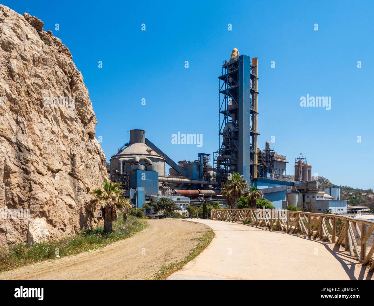 Cement factory in front of the sea on the coast of Málaga Stock Photo