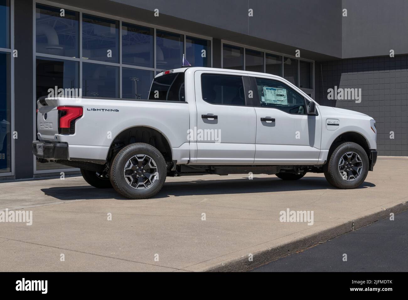 Plainfield - Circa July 2022: Ford F-150 Lightning display. Ford offers the F150 Lightning all-electric truck in Pro, XLT, Lariat, and Platinum models Stock Photo