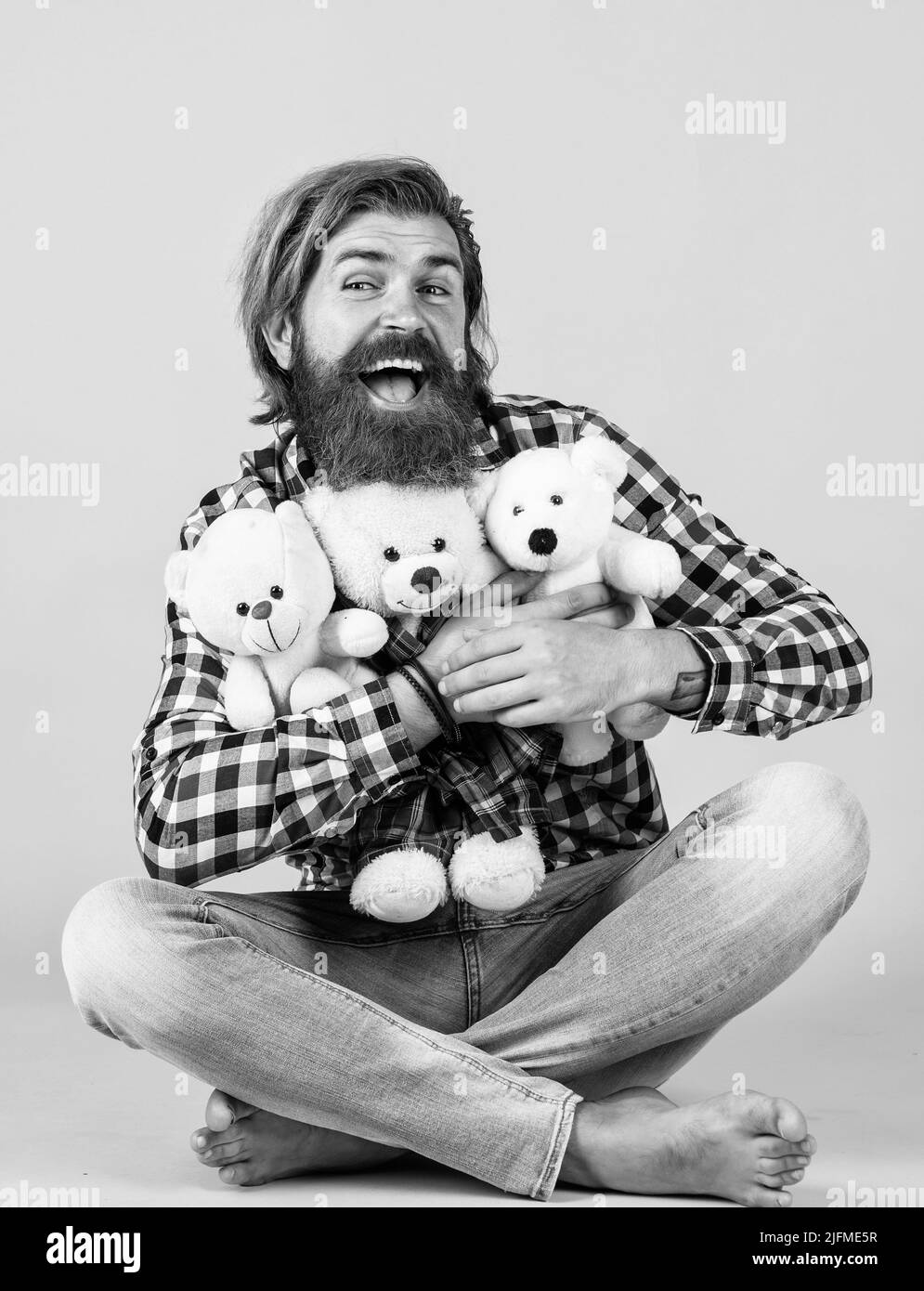 embrace with love. male feel playful with bear. brutal mature hipster man play with toy. happy birthday. being in good mood. happy valentines day Stock Photo
