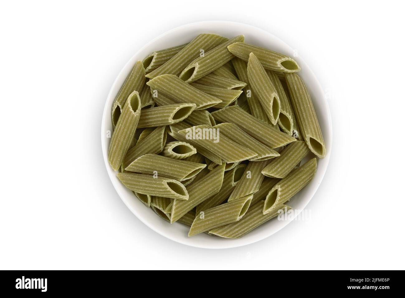Green pea penne pasta in ceramic bowl isolated on white background. Organic food speciality. Gluten free. Top view. Flat lay Stock Photo