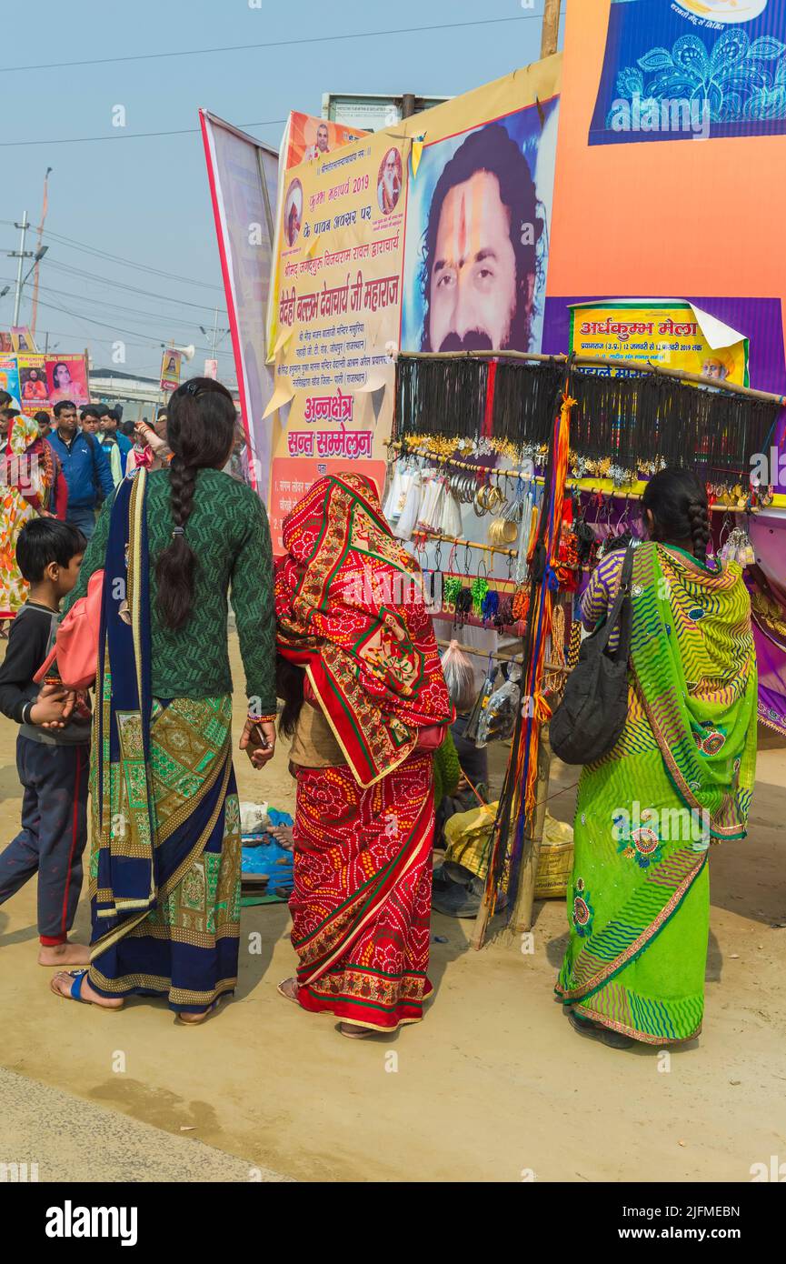 Pilgrims under giant posters, Allahabad Kumbh Mela, World’s largest religious gathering, Uttar Pradesh, India Stock Photo