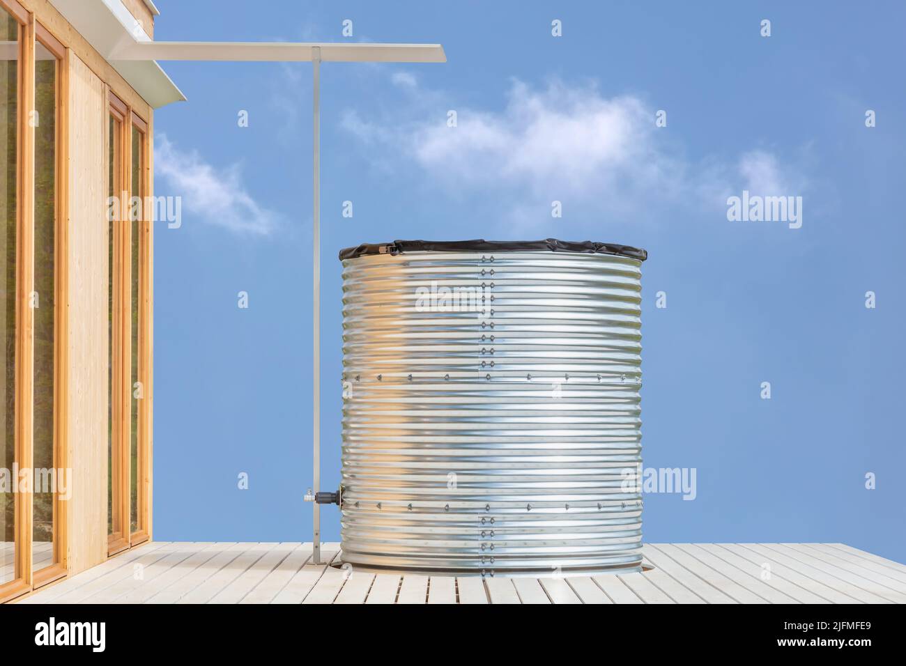 Modern large home water tank for collecting and storing rainwater Stock Photo
