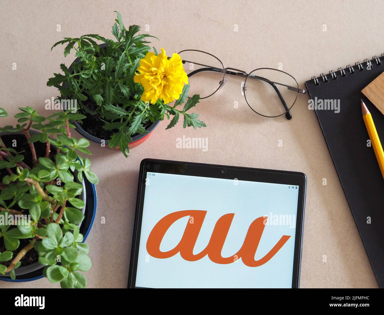 Germany. 04th July, 2022. In this photo illustration, au by KDDI, a Japanese mobile phone operator logo seen displayed on a tablet. Credit: SOPA Images Limited/Alamy Live News Stock Photo