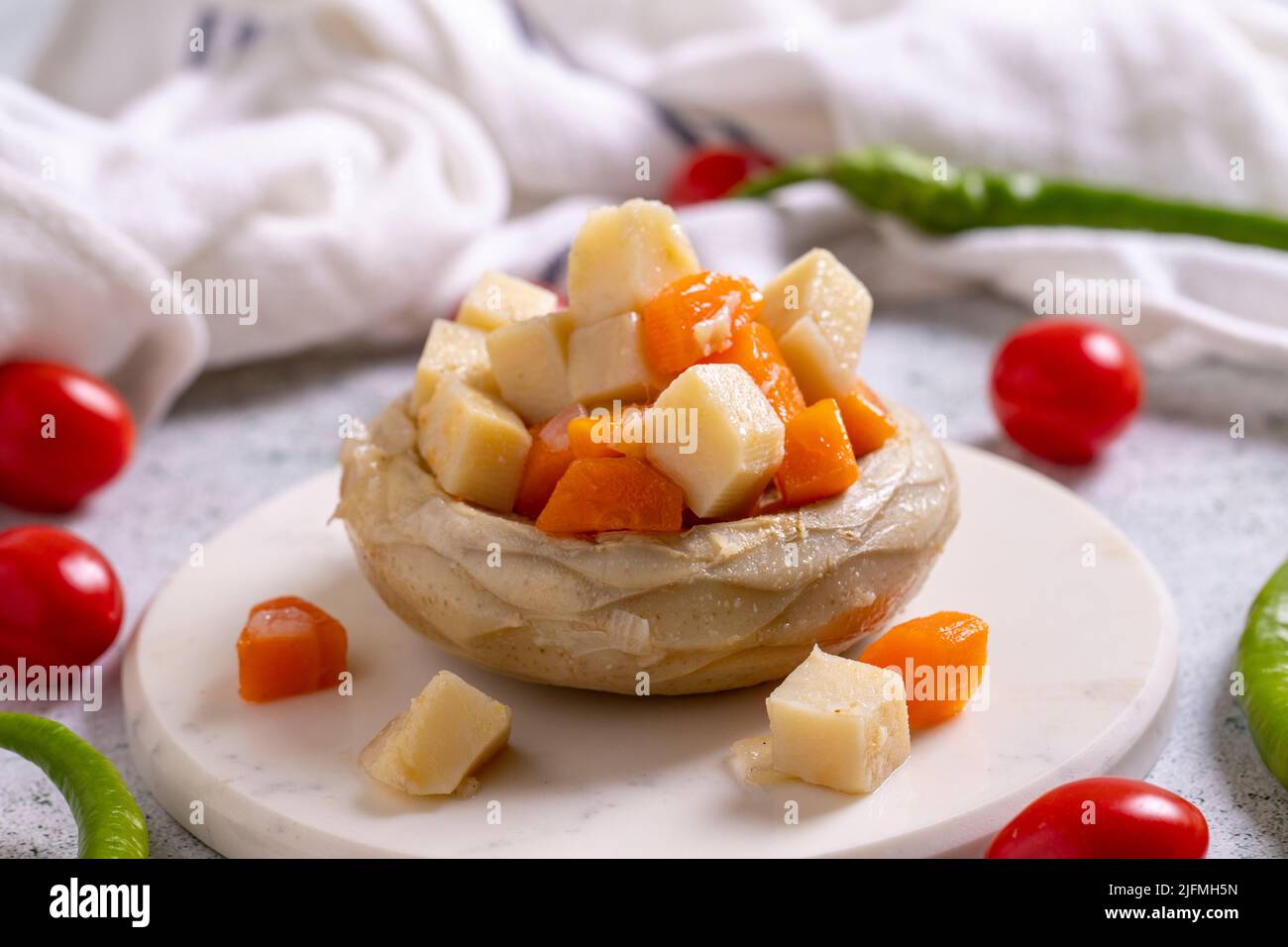 Artichokes with olive oil on a stone background. Garnish Artichoke. Healthy foods. local name