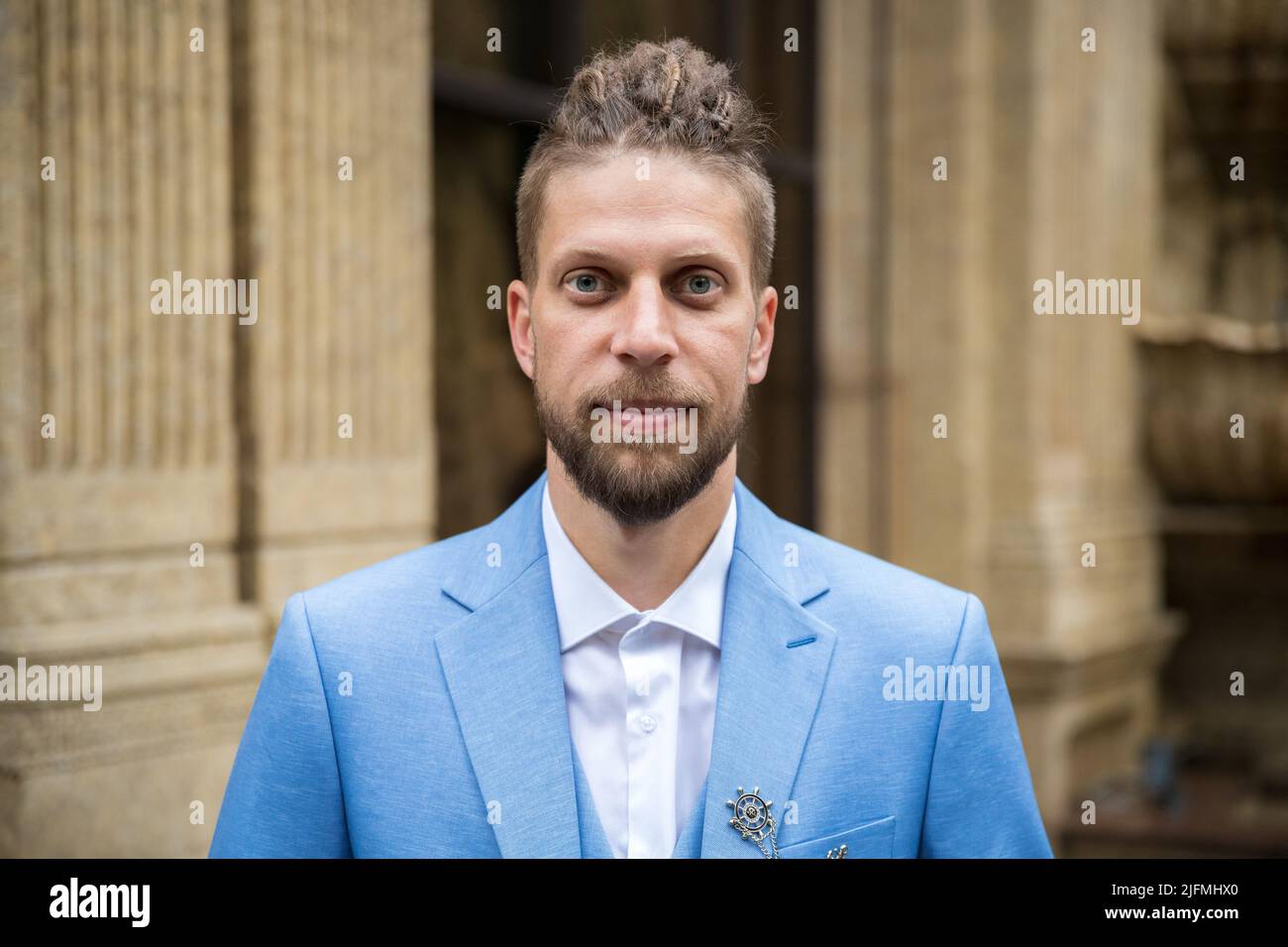 Man in blue three piece suit, outdoor portrait Stock Photo