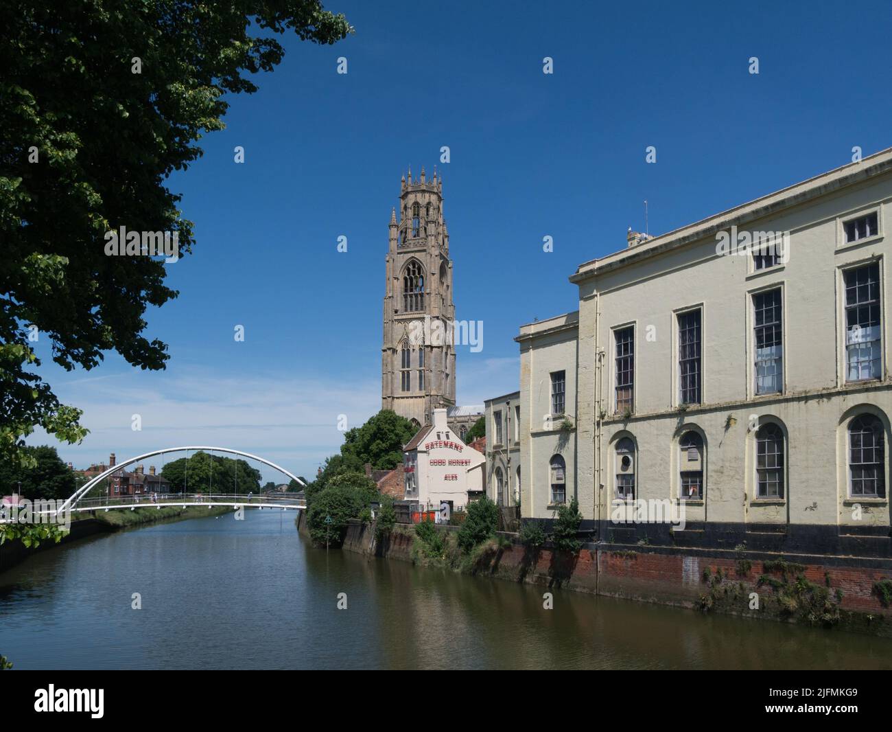 View along River Witham towards St Botolph's Church tower and St Botolph's pedestrian bridge Boston Lincolnshire England UK Stock Photo