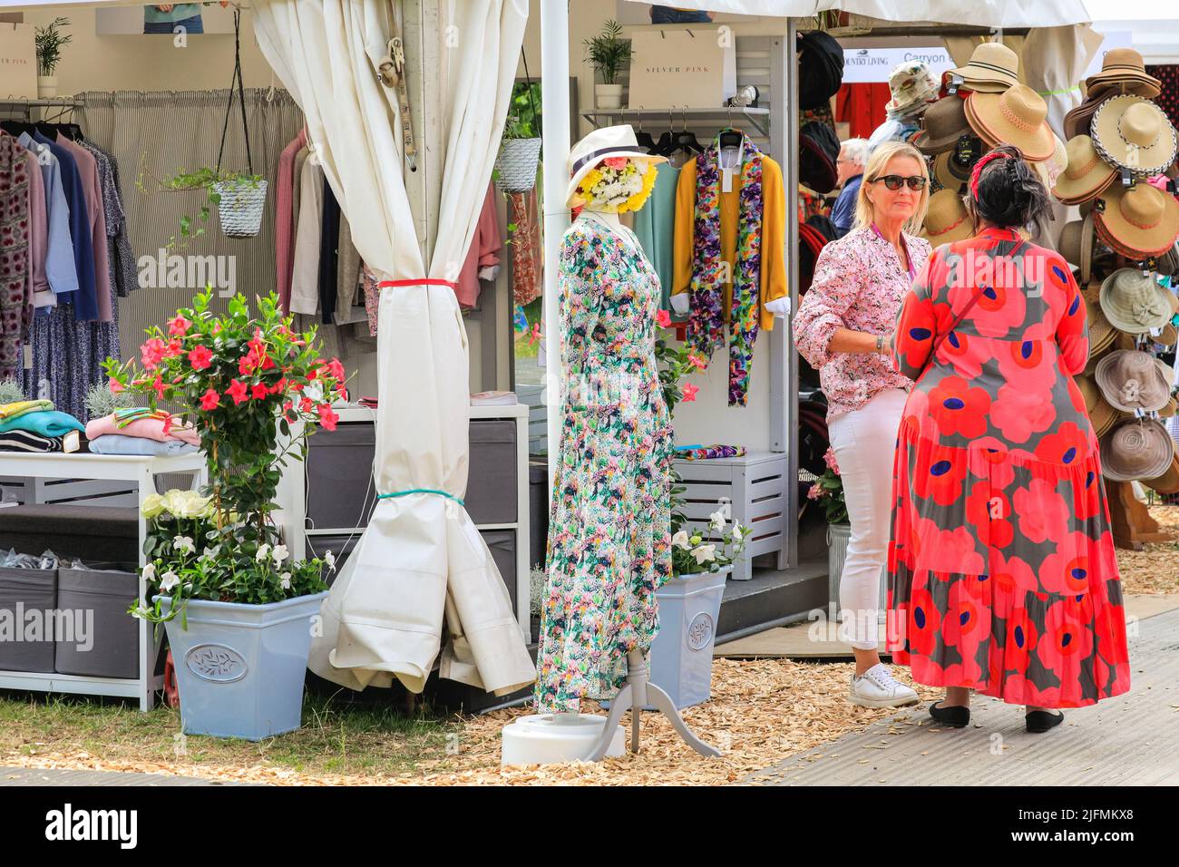 Hampton Court, London, UK. 04th July, 2022. Visitors in brightly coloured dresses at the show. Press preview day at RHS Hampton Court Palace Garden Festival (formerly The Hampton Court Flower Show). Credit: Imageplotter/Alamy Live News Stock Photo