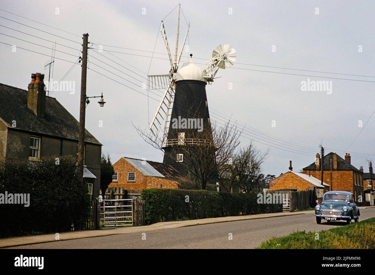 Historic windmill with Morris Minor car, Heckington, Lincolnshire, England, UK early 1960s also known as Pocklington's Mill Stock Photo