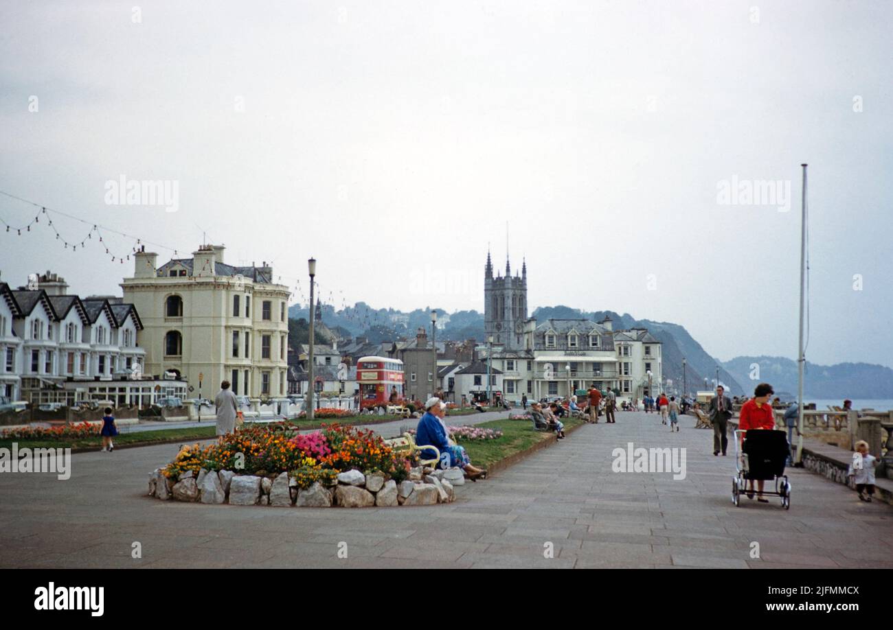 Flowers and lawn gardens, people walking on promenade, Teignmouth, Devon, England, UK early 1960s Stock Photo