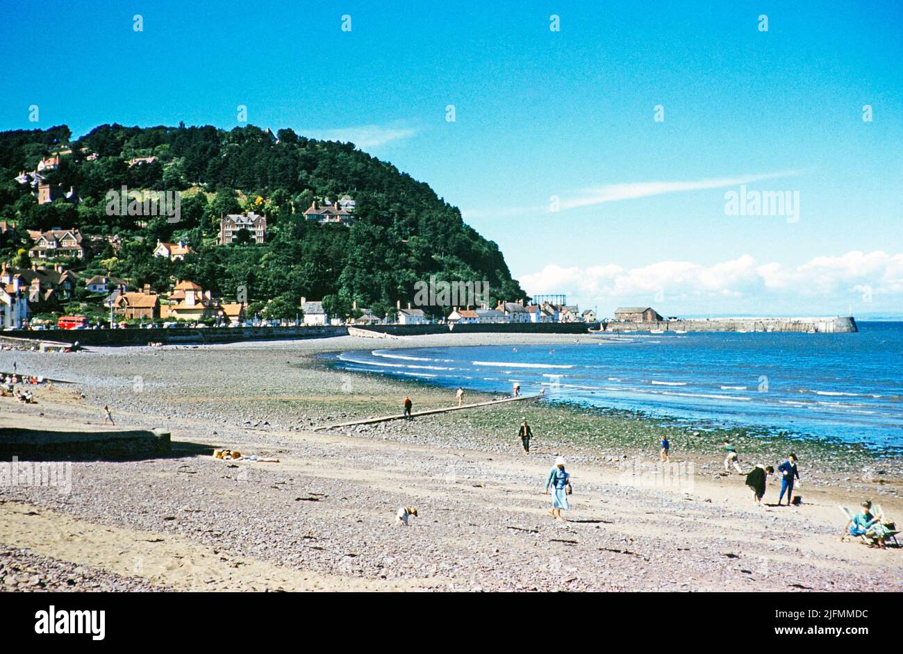 People on the beach with view to North Hill, Minehead, Somerset, England, UK early 1960s Stock Photo