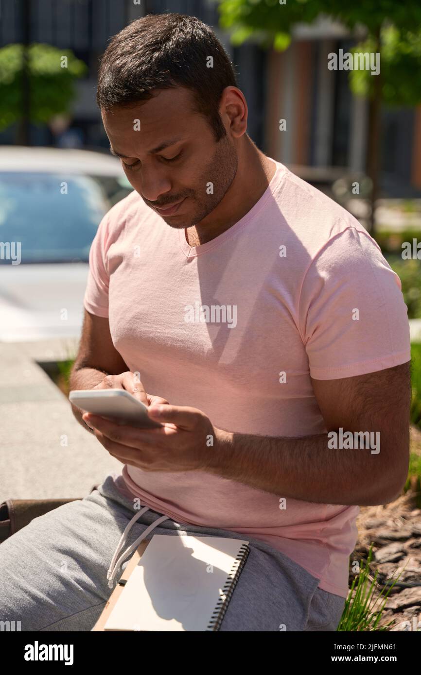 Focused man surfing Web using mobile phone Stock Photo