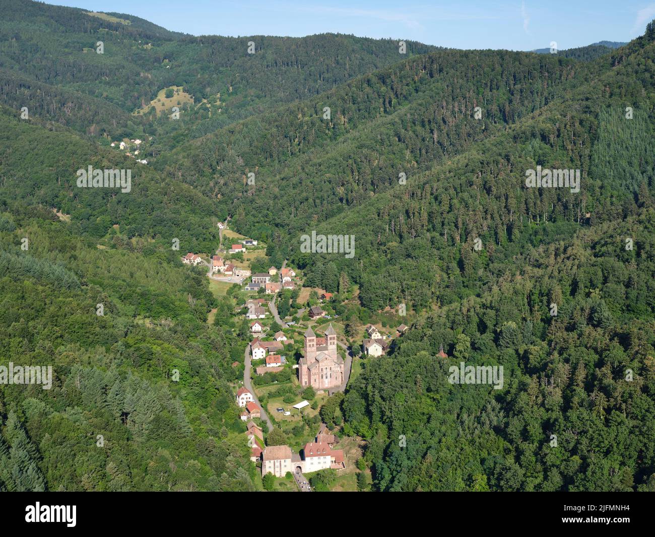 AERIAL VIEW. remote medieval abbey in the Eastern Vosges mountains. Murbach Abbey, Haut-Rhin, Alsace, Grand Est, France. Stock Photo