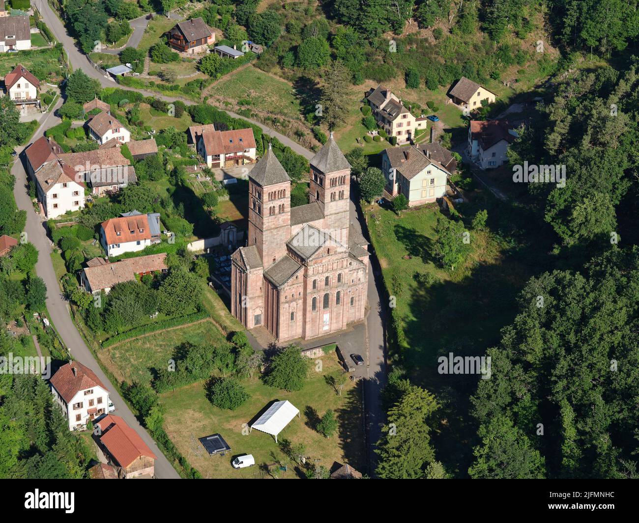 AERIAL VIEW. remote medieval abbey in the Eastern Vosges mountains. Murbach Abbey, Haut-Rhin, Alsace, Grand Est, France. Stock Photo