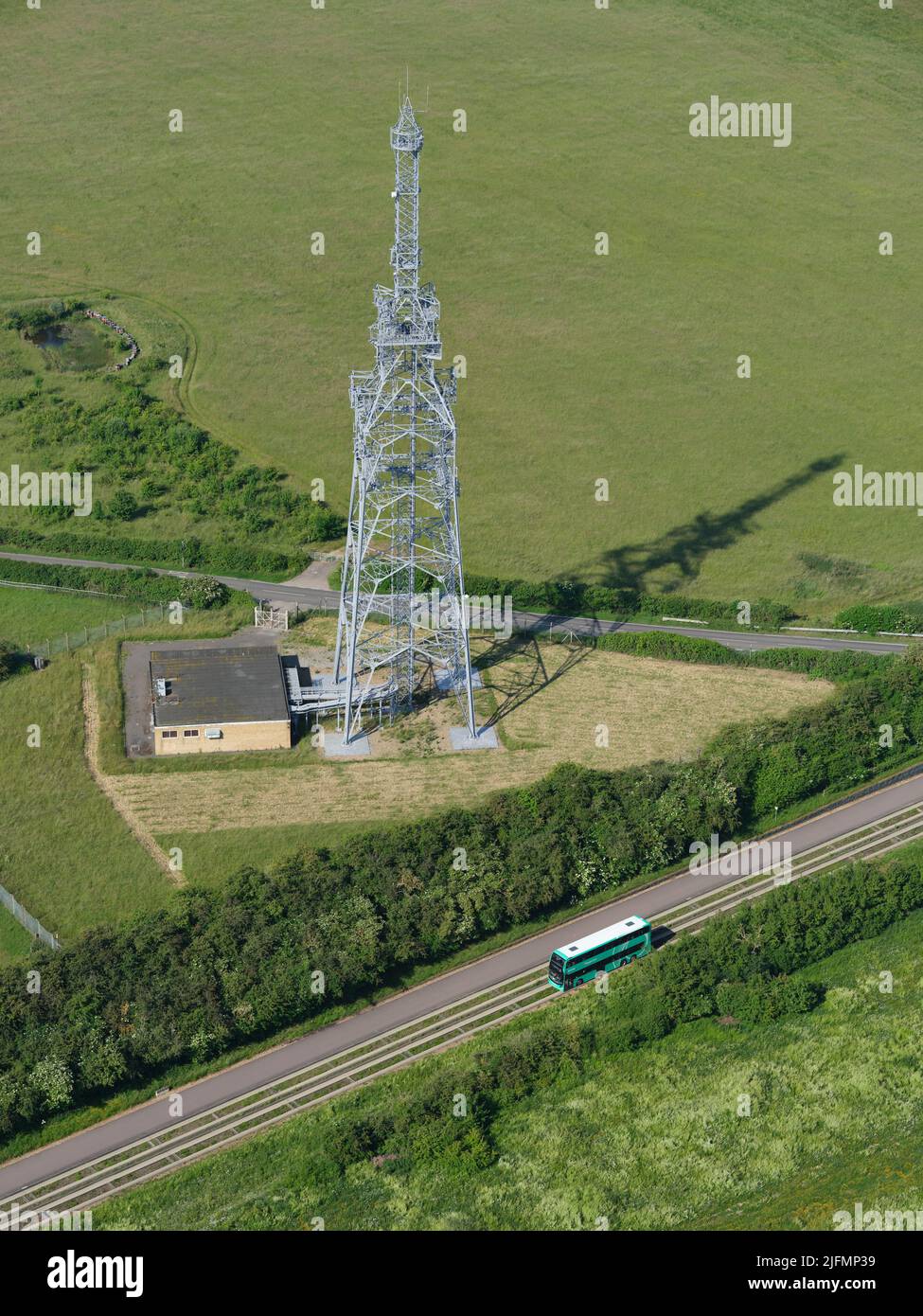 AERIAL VIEW. Double-decker bus on a guided busway in the countryside north of Cambridge. Over, Cambridgeshire, England, United Kindgom. Stock Photo
